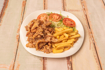 Great kebab dish with grilled meat on skewers, basmati rice, roasted tomatoes