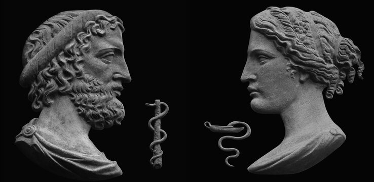 God of healing, Asclepius, admonishing his daughter, the goddess of medicine Giga. Ancient stone statues on a black background. Black and white image.