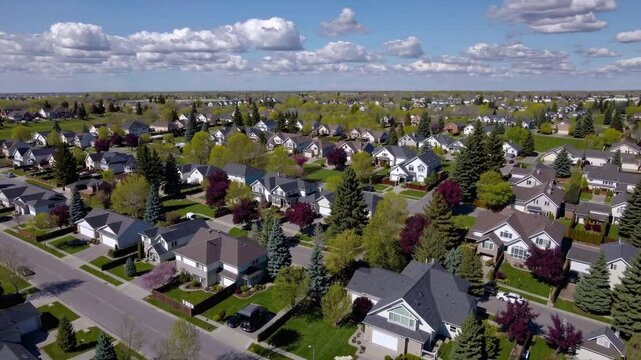 Residential Haven: An aerial vista unveils a picturesque suburban neighborhood, with rows of homes nestled amongst lush greenery, conveying a sense of community and tranquility.