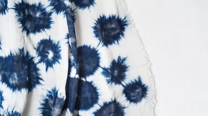 Indigo tie-dye on white silk. Handmade fabric with a unique knotted design. A special dyeing method called shibori was used.
