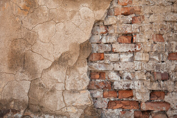 Old distressed vintage wall bricks background with cracked cement