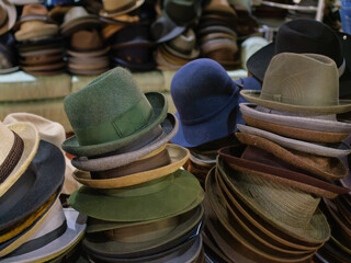 Collection of Various Hats Arranged on Surface in a Market Setting