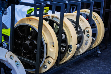 Multiple run-flat tire inserts fitted within car wheel rims, stored on a rack, showcasing...