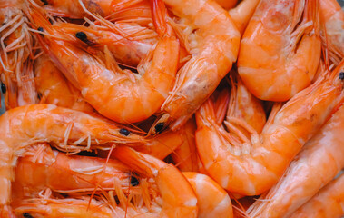Close-up image of freshly cooked shrimps with vibrant orange color and glossy texture