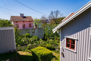 Picturesque colony of old small wooden historic houses on the Slottsberget mountain on the banks of the Gota alv river, Gothenburg, Sweden, sunny day