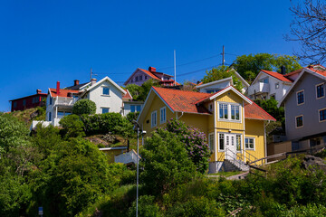 Picturesque colony of old small wooden historic houses on the Slottsberget mountain on the banks of the Gota alv river, Gothenburg, Sweden, sunny day