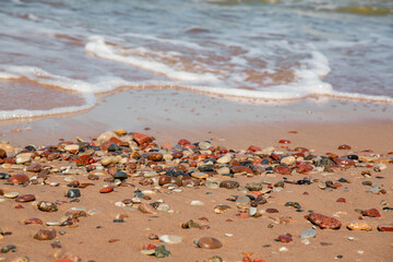Sunlit seaside stones at the Baltic sea on a sunny day in May in Jurkalne in Latvia