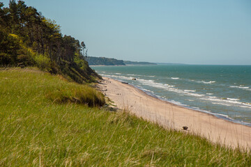 Steep coast of Baltic sea in Jurkalne on a sunny day in May in Latvia
