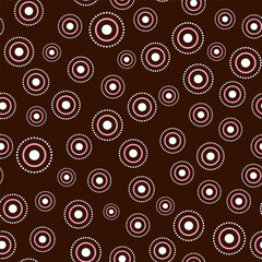 Seamless pattern with random round elements. White pink circular element on dark brown background. Ethnic simple geometric vector illustration. Country style folk ornament for holiday decor