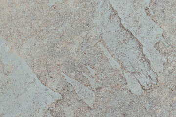 Weathered stone surface of exterior architectural wall. Abstract rough background