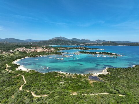 Aerial view of a white sand beach bathed by a beautiful turquoise sea. Marinella Beach, Porto Rotondo, Sardinia, Italy