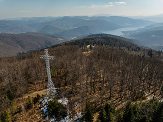 Aerial drone view of beskid mountains in spring. Chrobacz Meadow peak in the Magurka Wilkowicka Group in the Little Beskids. Cross on a mountaintop in the Beskids..