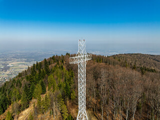 Aerial drone view of beskid mountains in spring. Chrobacz Meadow peak in the Magurka Wilkowicka Group in the Little Beskids. Cross on a mountaintop in the Beskids..