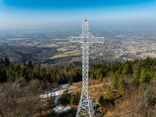 Aerial drone view of beskid mountains in spring. Chrobacz Meadow peak in the Magurka Wilkowicka Group in the Little Beskids. Cross on a mountaintop in the Beskids..