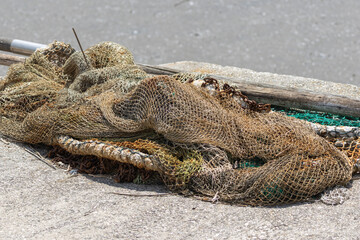 Fishing nets drying on a concrete dock under the sun