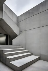 Obraz premium Modern concrete building with geometric design and large staircases. Ideal for themes related to architecture, urban development