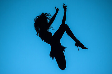 Silhouette of a drag queen mid-death drop