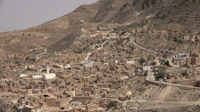 Road cuts through small village of Toujane, mountain landscapes and transport in Tunisia
