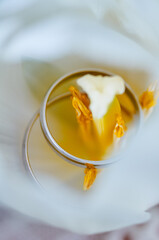 Close-Up of Wedding Rings Inside a Soft White Flower..