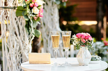 Elegant Table Decor Featuring Flowers and Champagne Flutes for Celebration..