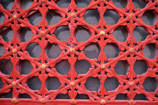 Naklejki Ornate Red Decorative Panel with Gold Accents in Geometric Pattern..
