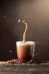 Coffee and chocolate drink with cream on a brown background.