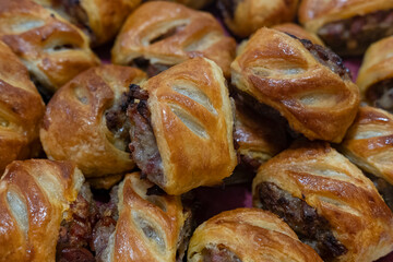 Freshly baked sausage rolls made with golden, flaky puff pastry and filled with seasoned meat mixture, a classic homemade snack popular as appetizers during the festive gatherings like Christmas day