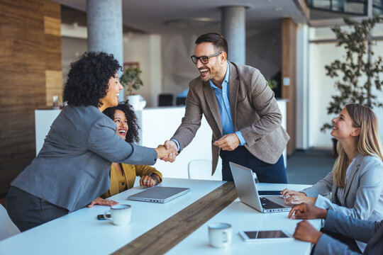 Professional Team Celebrates Successful Collaboration in Modern Stylish Office Environment - Powered by Adobe