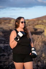 Athletic woman practicing boxing in unique desert-like landscape in Tenerife, Canary Islands, Spain, expression of body positivity, outdoor training, female empowerment far from the confines of a gym