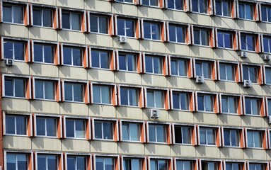 Facade of an old soviet residential, office building with repetitive pattern of windows, many...
