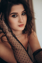 Close-up portrait of a woman with sheer dotted gloves