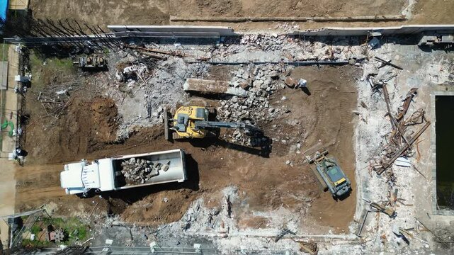 Backoes clean up the ruins after the Pacific Palisades Fire