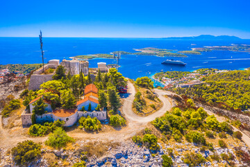 Aerial view of Napoleon Fortress on Hvar Island, Croatia, showcasing its strategic hilltop location overlooking the Adriatic Sea, and nearby Pakleni Islands in a Mediterranean setting