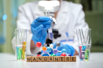 A scientist analyzes manganese using colorful samples and lab equipment, highlighting their...
