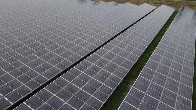 4K Aerial View of Industrial Factory with Solar Panels on Roof Producing Clean Energy