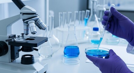 Scientist in gloves pipetting blue liquid into petri dish in a modern laboratory setting