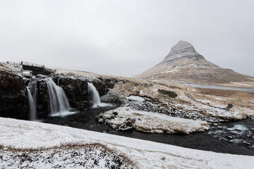 Winter Landscape with Kirkjufell Mountain and Frozen Waterfalls in Iceland
