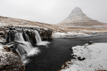 Winter Landscape with Kirkjufell Mountain and Frozen Waterfalls in Iceland