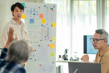 Programmer mentoring college senior adult students in software development, sharing knowledge and fostering innovation in a collaborative classroom.

