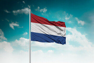 High-resolution stock image of a gently billowing Netherlands national flag mounted on a modern...