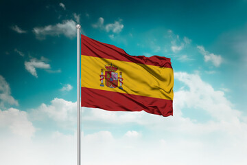 High-resolution stock image of a gently billowing Spain national flag mounted on a modern flagpole...