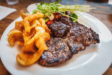 Rib eye Steak with potato chips and salad
