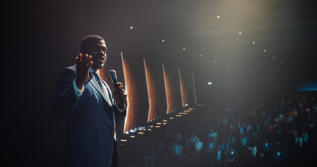 Black Man Making a Life Coaching Session for People Wishing to Have a Healthy and Successful Personal and Professional Life. African Lifestyle Specialist Making a Presentation to a Big Audience