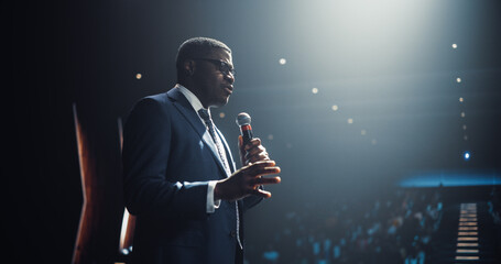Businessman Giving a Talk at a Global Finance Summit. Audience Listening to His Insightful Talk....