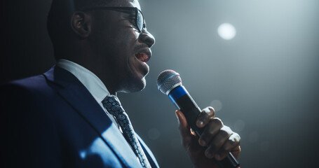 Close Up of a Celebrity Public Speaker Giving an Inspiring Talk at an International Business Development Conference. African Man Using a Microphone to Deliver a Strong Message and Coaching Advice