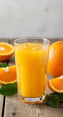 Fresh Orange Juice in a Tall Glass with Sliced Oranges on a Rustic Table