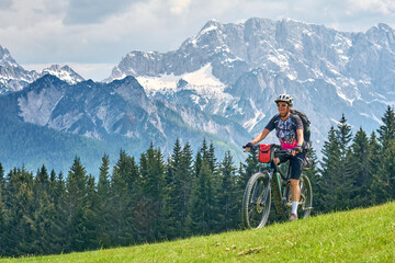 active senior woman on a mountain bike tour in the Julian Alps above Kranska Gora in Slovenia
