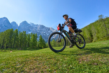 active senior woman on a mountain bike tour in the Julian Alps above Kranska Gora in Slovenia

