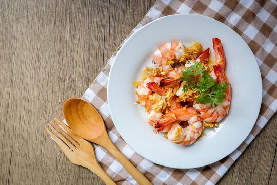 Stir Fried Shrimps with Garlic on white ceramic plate, home cook