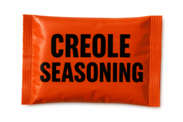 Orange packet of creole seasoning on transparent background
